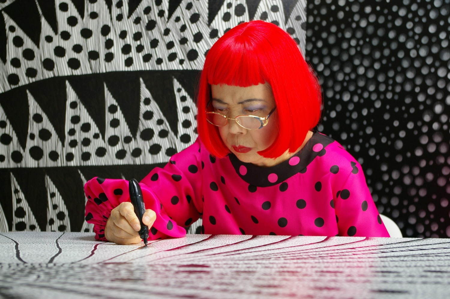 Artist Yayoi Kusama drawing in KUSAMA -INFINITY.
 © Tokyo Lee Productions, Inc. Courtesy of Magnolia Pictures.